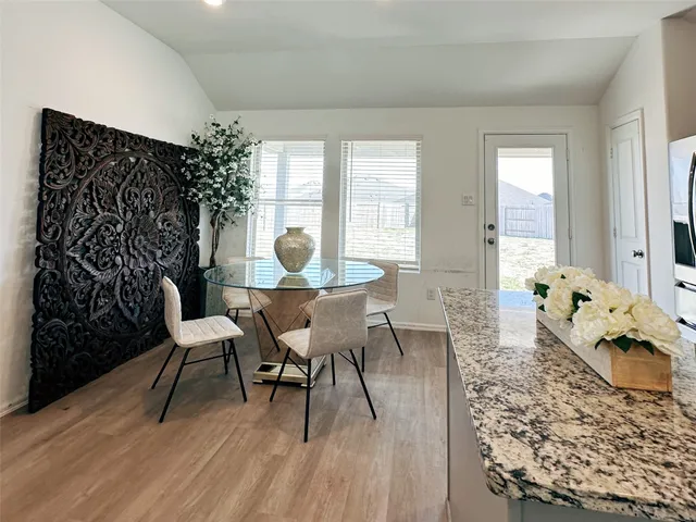 a view of a dining room with furniture and wooden floor