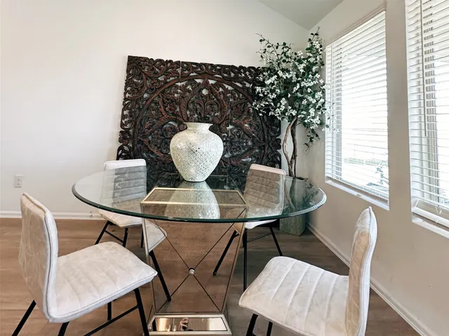 a view of a dining room with furniture and wooden floor