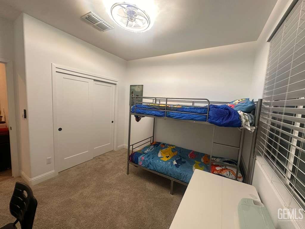 Undisclosed Address Shafter, CA 93263 - Photo 12 of 25 a bedroom with a bed and a chandelier