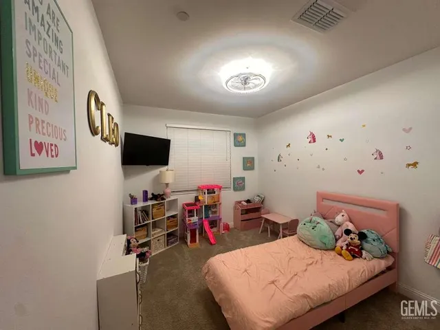 a bedroom with furniture and a flat screen tv