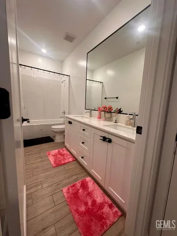 a bathroom with a sink vanity and mirror