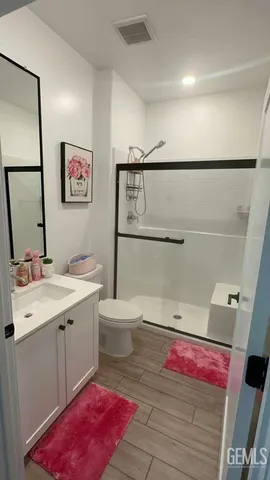 a spacious bathroom with a sink mirror vanity and toilet