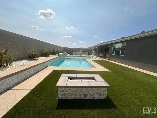 a view of a swimming pool with an outdoor seating