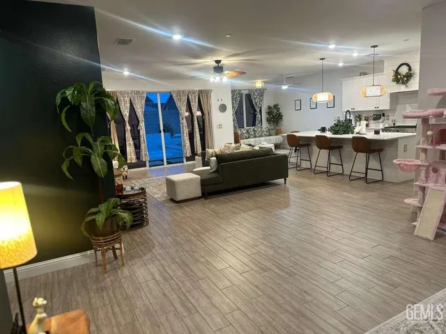 a living room with furniture and a potted plant