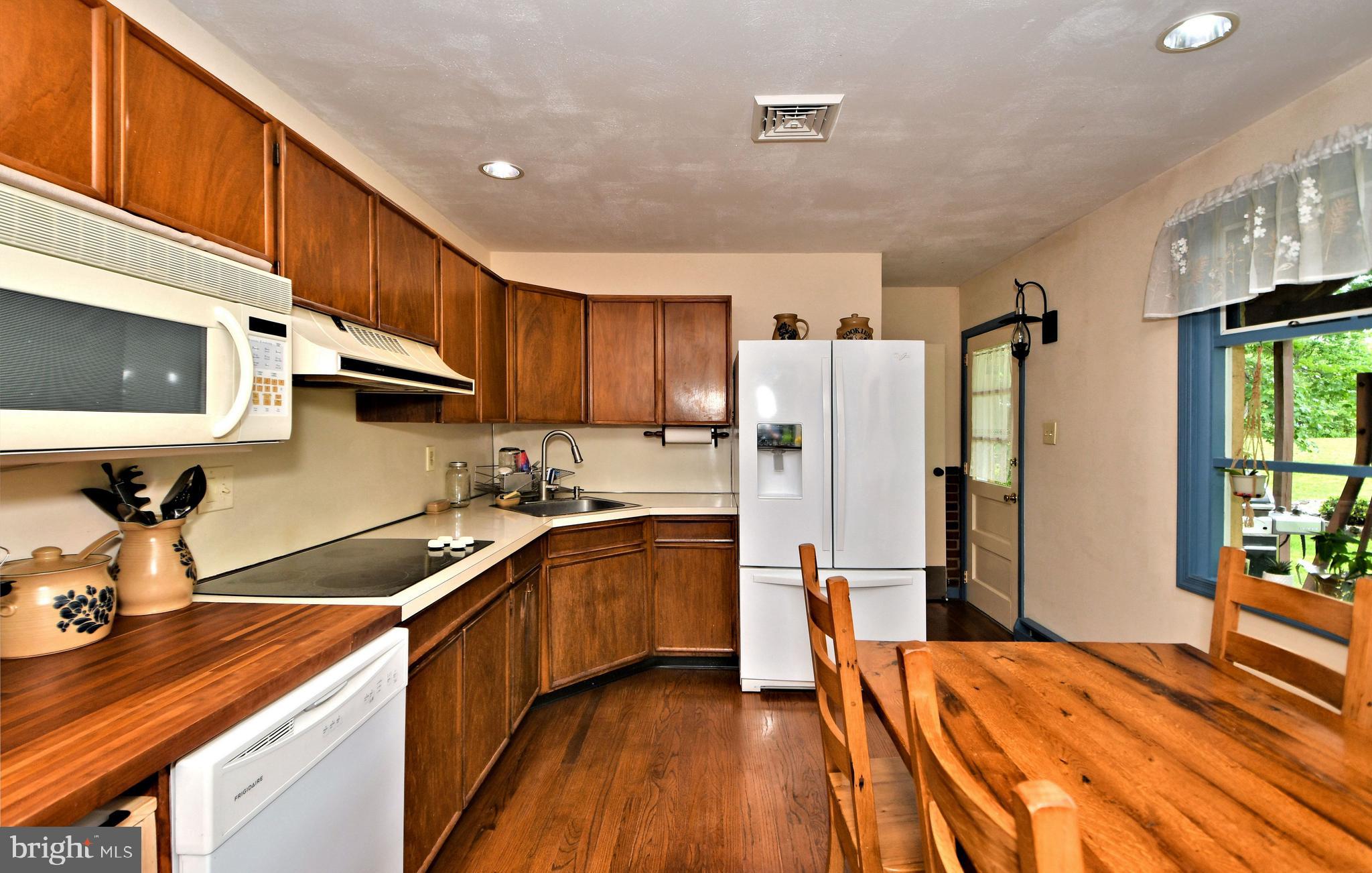24 Moyer Road Telford, PA 18969 - Photo 11 of 62 a kitchen with stainless steel appliances granite countertop a refrigerator a sink dishwasher a stove and a oven with wooden floor
