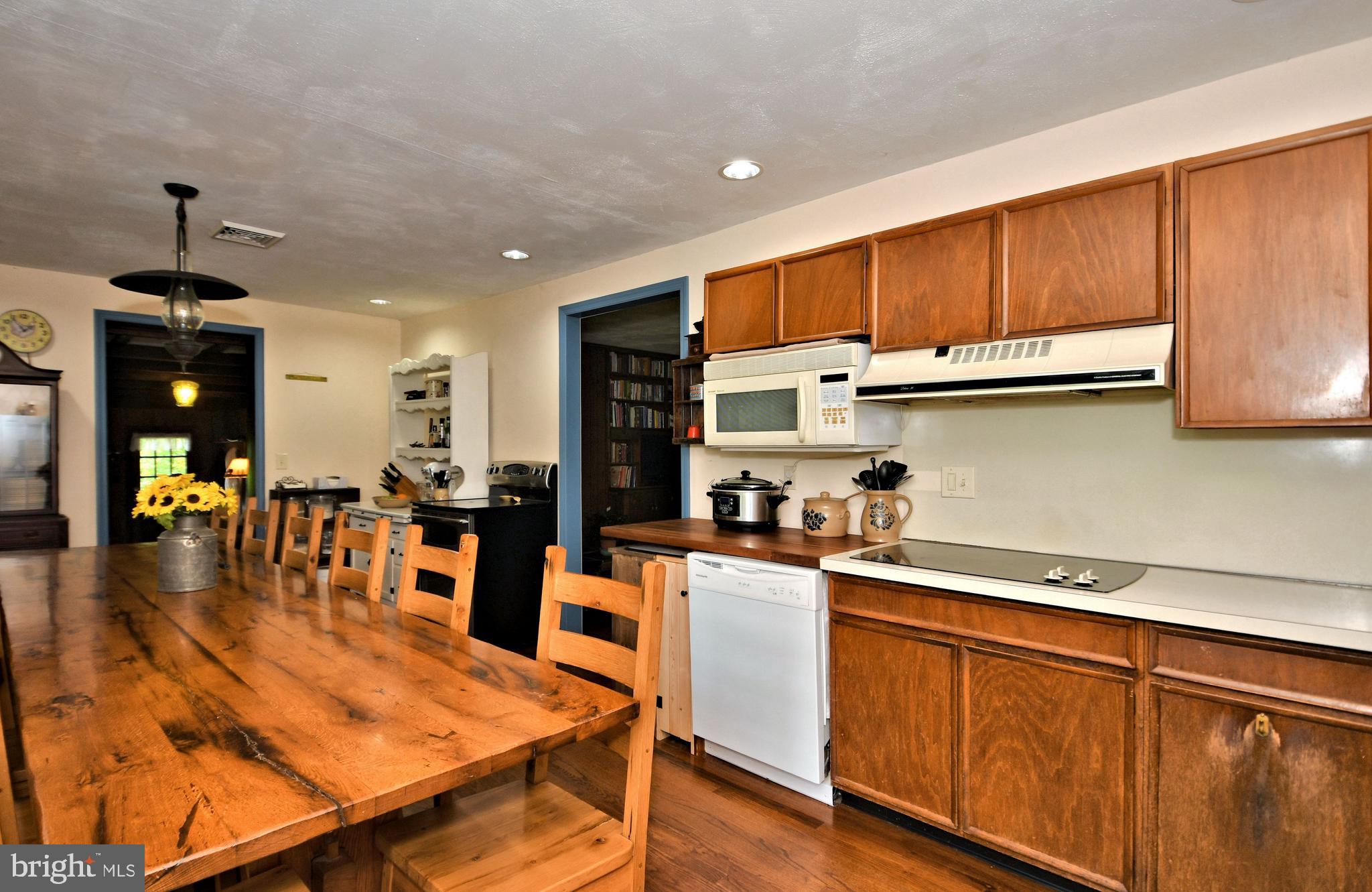 24 Moyer Road Telford, PA 18969 - Photo 12 of 62 a kitchen with stainless steel appliances granite countertop a refrigerator a sink dishwasher a stove and white cabinets with wooden floor