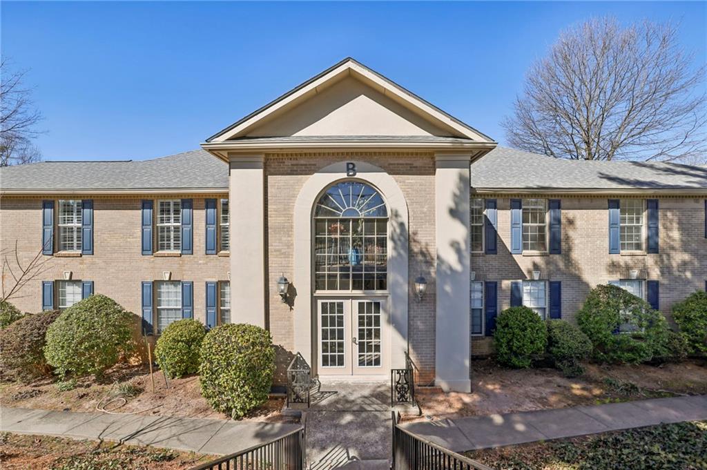 750 Dalrymple Road, Unit B4 Sandy Springs, GA 30328 - Photo 1 of 1 a front view of a house with garden