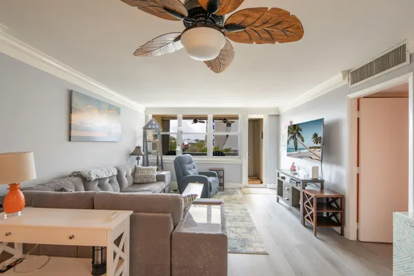 a living room with furniture and a chandelier