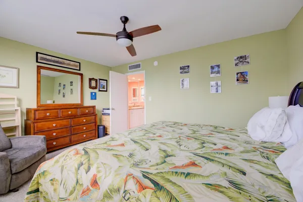 a bedroom with a bed and a dresser in it