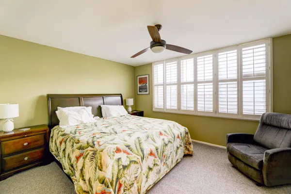 a bedroom with a bed and a couch