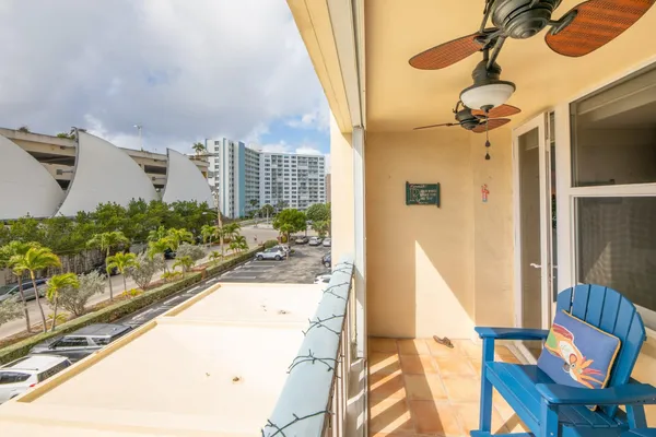 a view of a living room with a floor to ceiling window and wooden floor