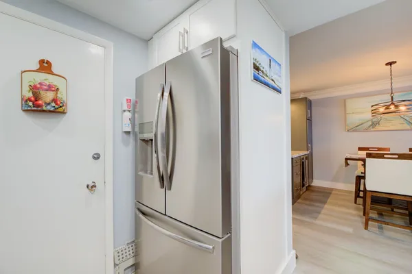 a metallic refrigerator freezer sitting in a kitchen