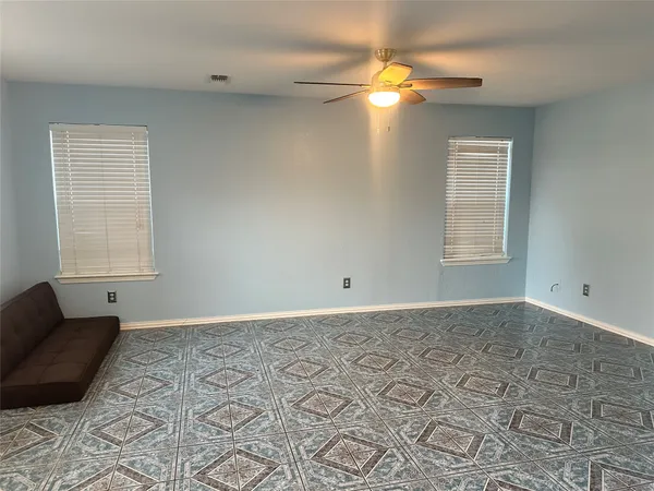 a view of a bedroom with a bed and a window