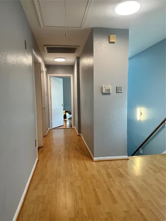 a view of a hallway with wooden floor