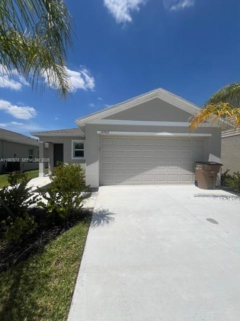 19709 Garden Ridge, Unit 19709 Lehigh Acres, FL 33974 - Photo 1 of 11 a front view of a house with a yard and potted plants