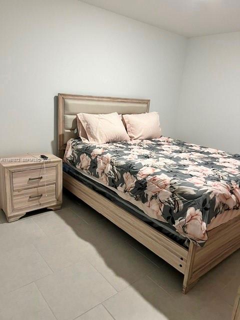 19709 Garden Ridge, Unit 19709 Lehigh Acres, FL 33974 - Photo 6 of 11 a bed sitting in a bedroom next to a window