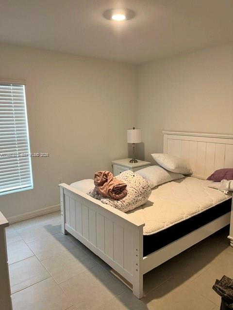 19709 Garden Ridge, Unit 19709 Lehigh Acres, FL 33974 - Photo 8 of 11 a bedroom with a bed and window