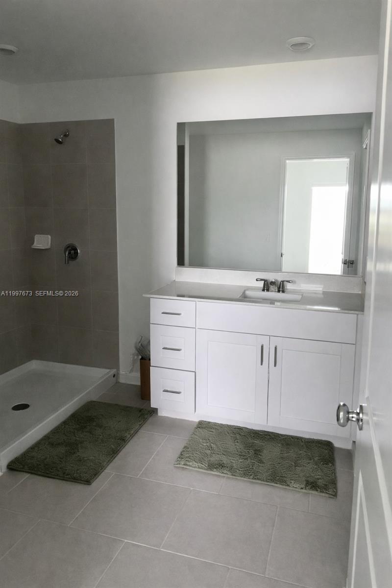 19709 Garden Ridge, Unit 19709 Lehigh Acres, FL 33974 - Photo 9 of 11 a bathroom with a sink and a mirror