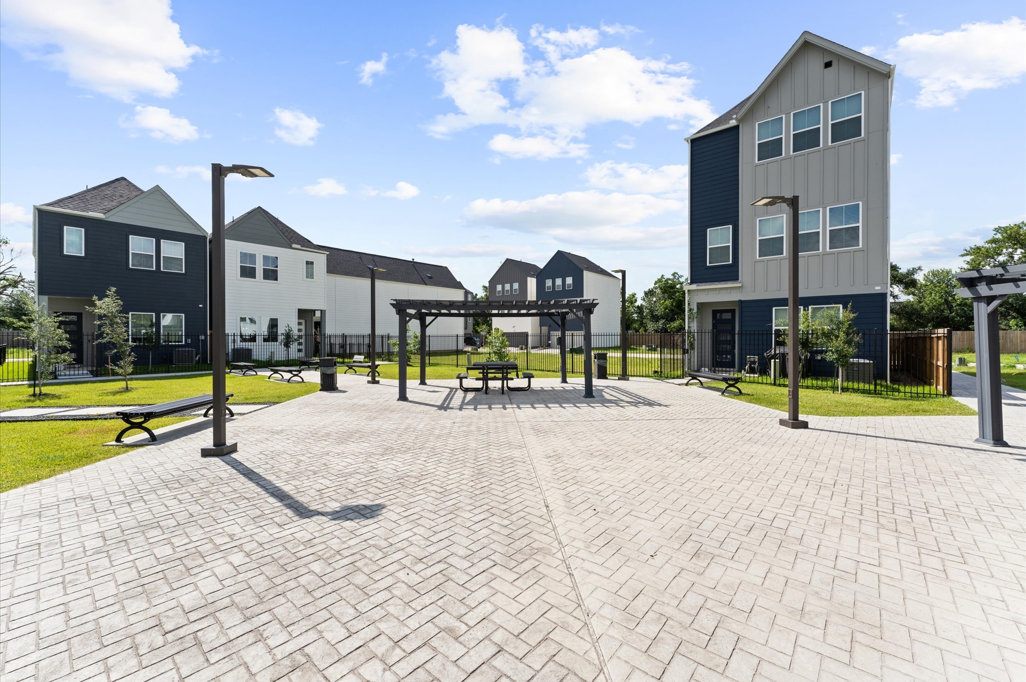 8319 Springwood Drive Houston, TX 77055 - Photo 32 of 47 This inviting courtyard serves as the heart of the neighborhood, where thoughtfully paved pathways lead to a tranquil open-air gathering space. Whether enjoying a quiet moment or mingling with neighbors, this shared space blends natural beauty with architectural charm—perfectly complementing the lifestyle of a vibrant gated community.