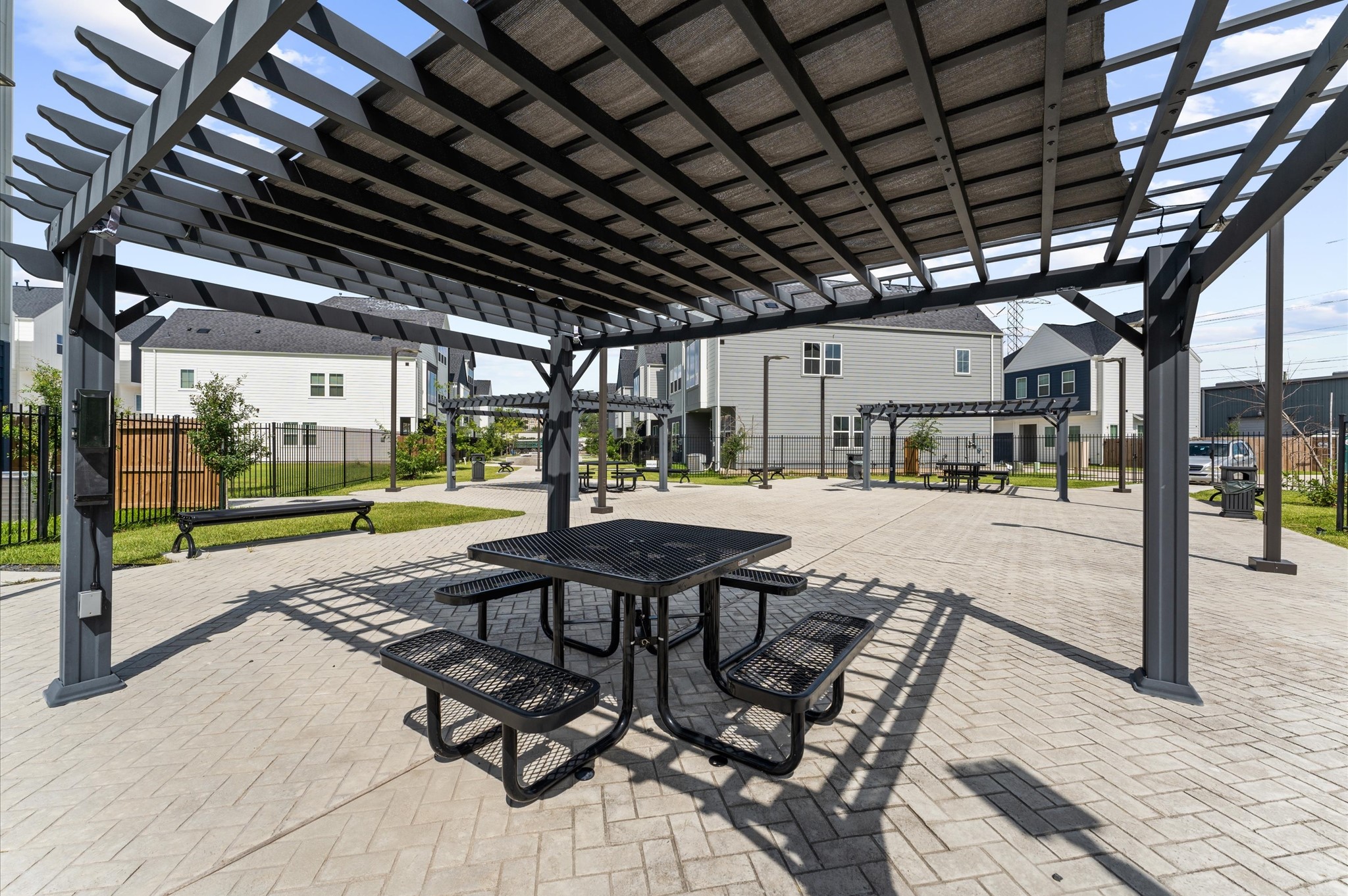 8319 Springwood Drive Houston, TX 77055 - Photo 33 of 47 This picturesque courtyard invites residents to unwind beneath elegant wooden pergolas, thoughtfully placed to offer shade and style. Meandering pathways lead to comfortable sitting areas, perfect for morning coffee, afternoon chats, or quiet reflection.