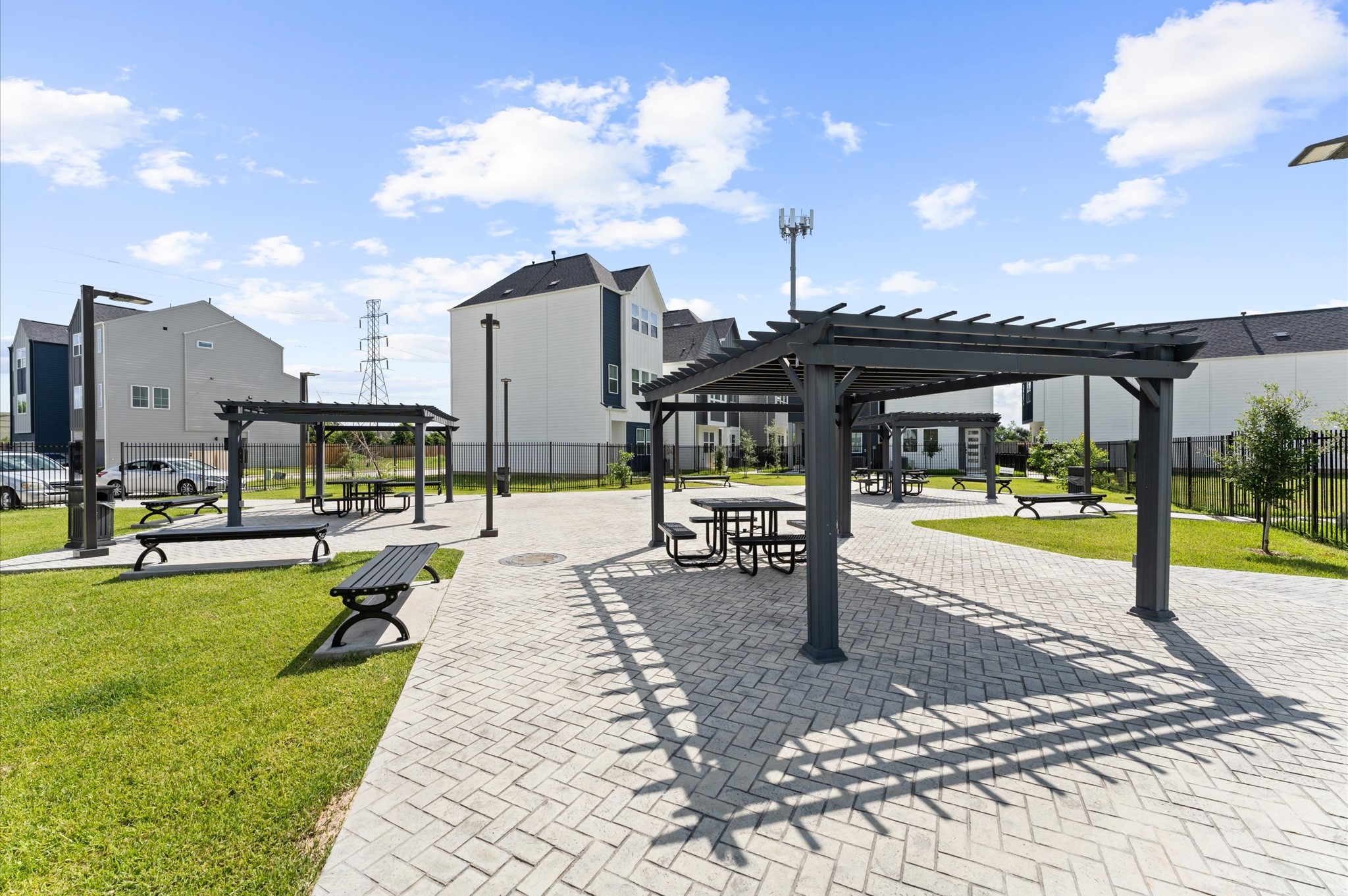 8319 Springwood Drive Houston, TX 77055 - Photo 34 of 47 This picturesque courtyard invites residents to unwind beneath elegant wooden pergolas, thoughtfully placed to offer shade and style. Meandering pathways lead to comfortable sitting areas, perfect for morning coffee, afternoon chats, or quiet reflection.