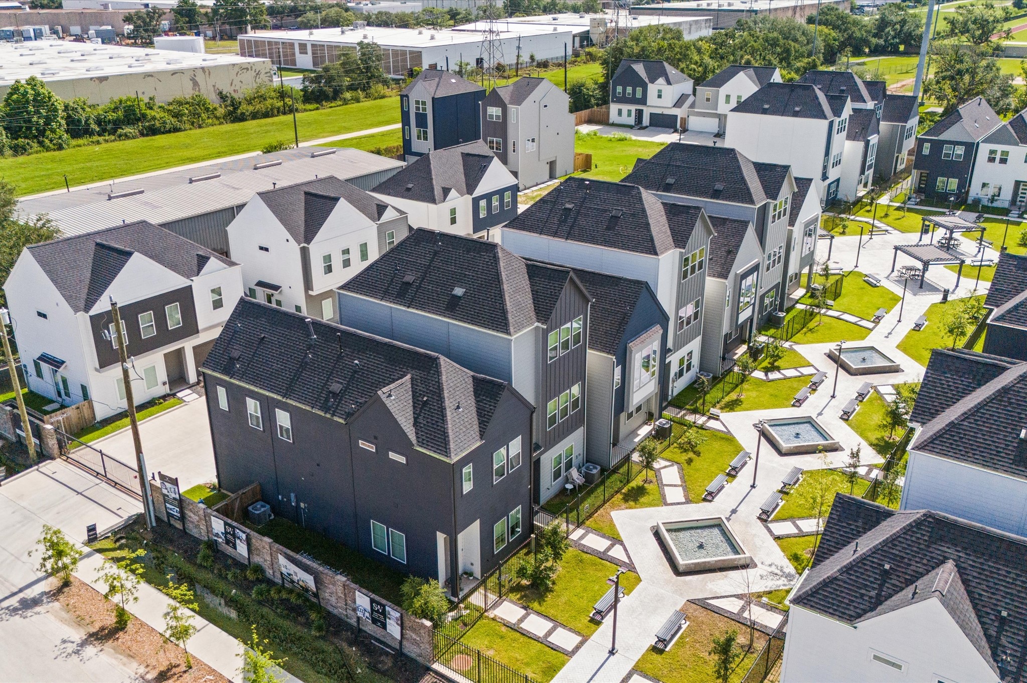 8319 Springwood Drive Houston, TX 77055 - Photo 35 of 47 From above, Springwood Villas reveals its harmonious blend of architecture, greenery, and shared spaces. Homes are arranged in elegant rows, connected by winding pathways that lead to a central community courtyard—a lush oasis featuring pergolas, shaded seating, and water fountains.