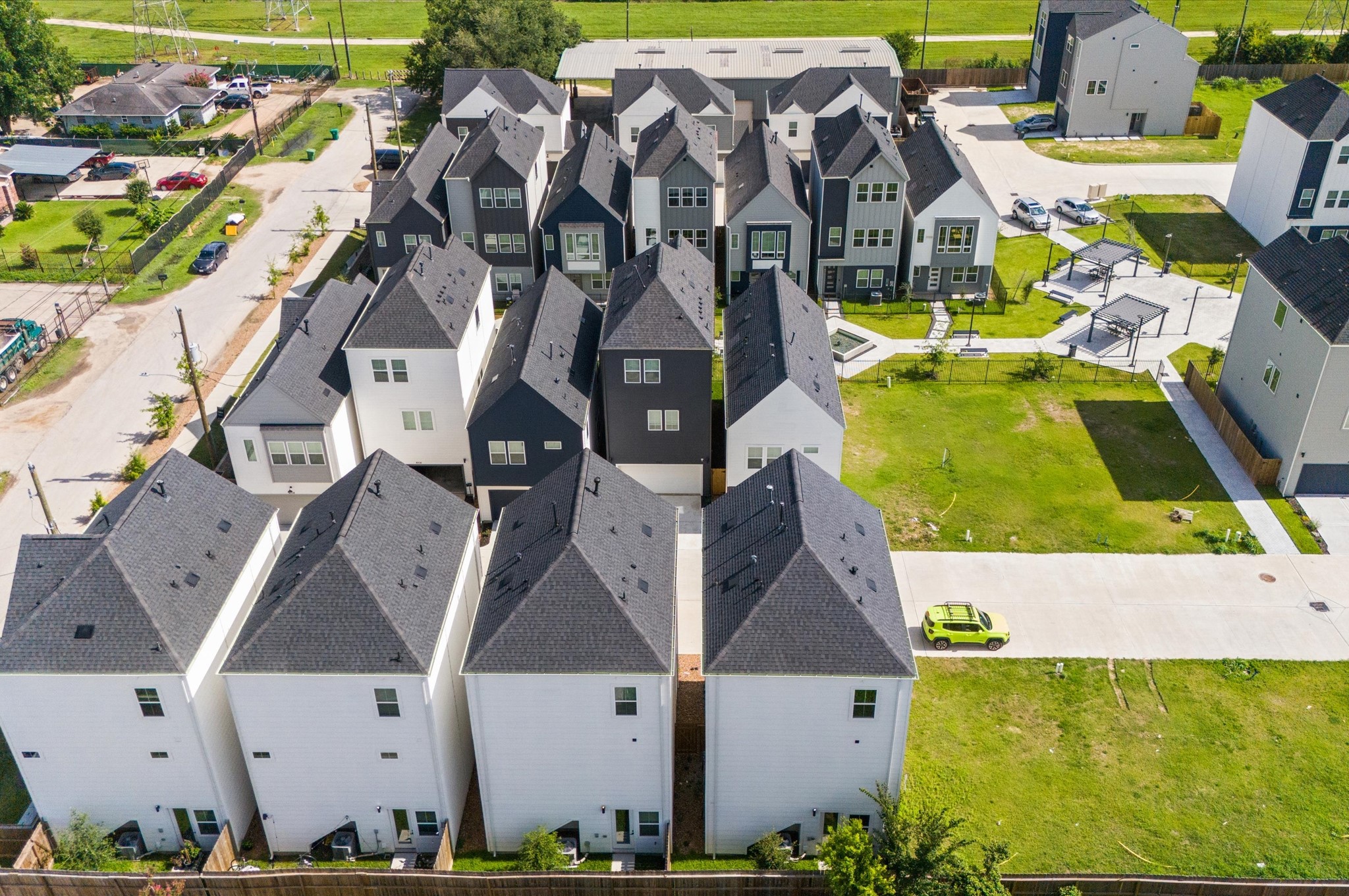 8319 Springwood Drive Houston, TX 77055 - Photo 36 of 47 From above, Springwood Villas reveals its harmonious blend of architecture, greenery, and shared spaces. Homes are arranged in elegant rows, connected by winding pathways that lead to a central community courtyard—a lush oasis featuring pergolas, shaded seating, and water fountains.