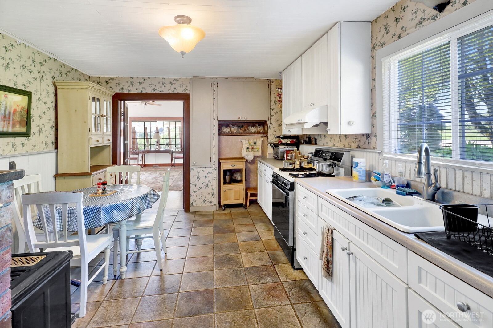 8172 Van Buren Road Everson, WA 98247 - Photo 11 of 33 a kitchen with stainless steel appliances a stove a sink a oven a dining table and chairs