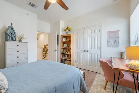 a bedroom with a bed and a chandelier