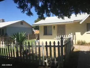 a view of a house with backyard porch and sitting area
