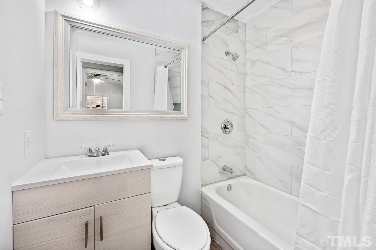 7002 Longstreet Drive, Unit C Raleigh, NC 27615 - Photo 13 of 18 a bathroom with a sink a toilet and shower