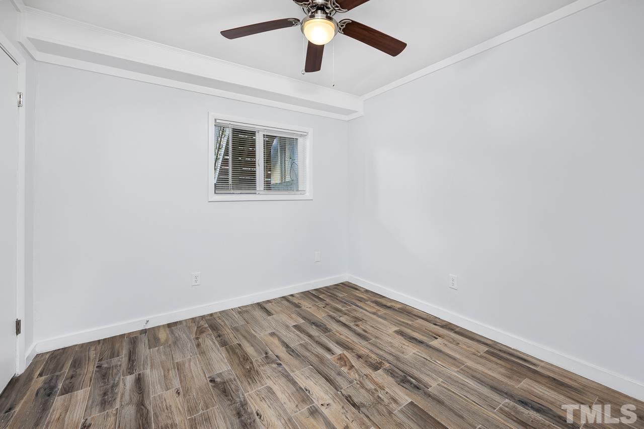 7002 Longstreet Drive, Unit C Raleigh, NC 27615 - Photo 14 of 18 a view of empty room with wooden floor
