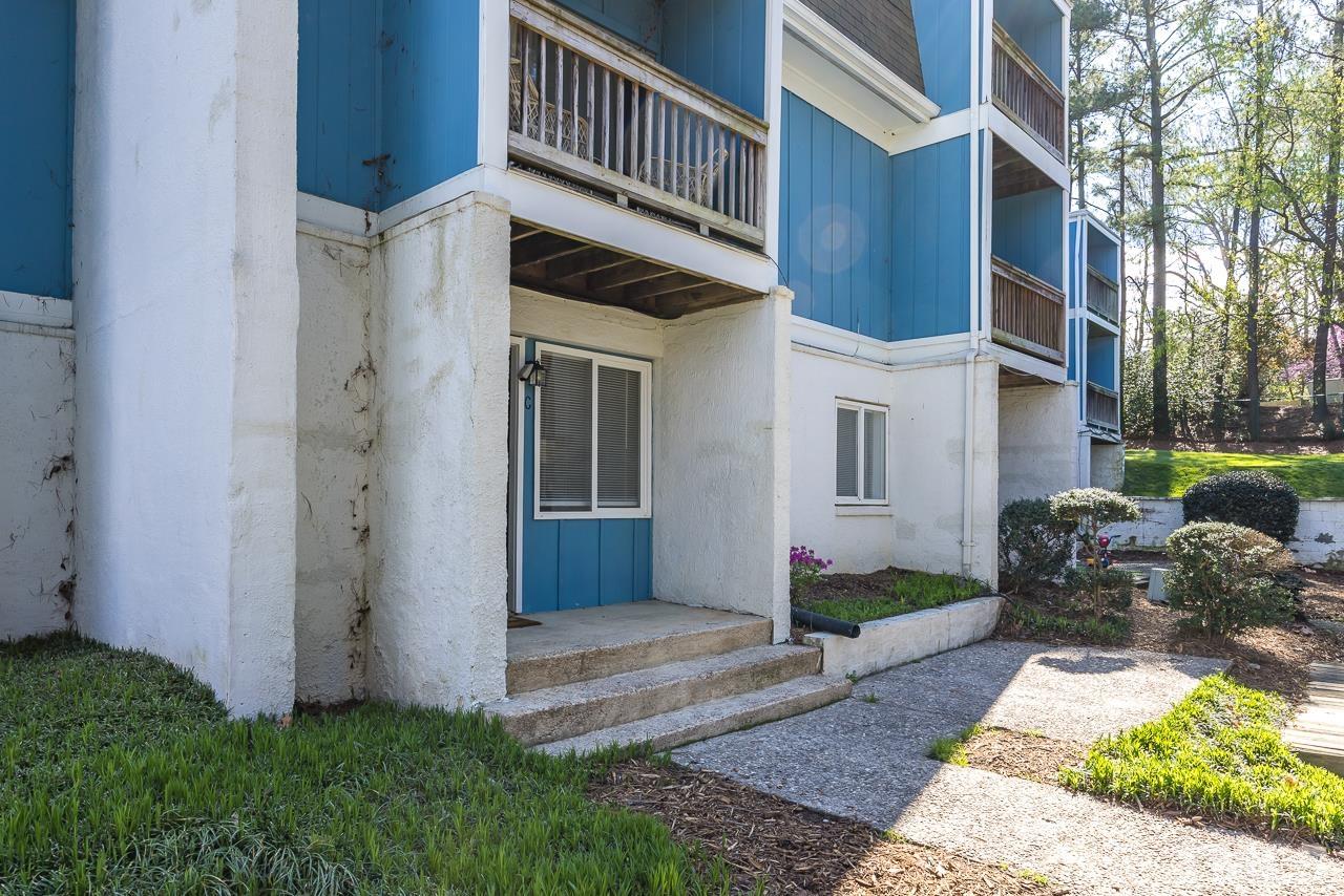 7002 Longstreet Drive, Unit C Raleigh, NC 27615 - Photo 17 of 18 a front view of a house with garden