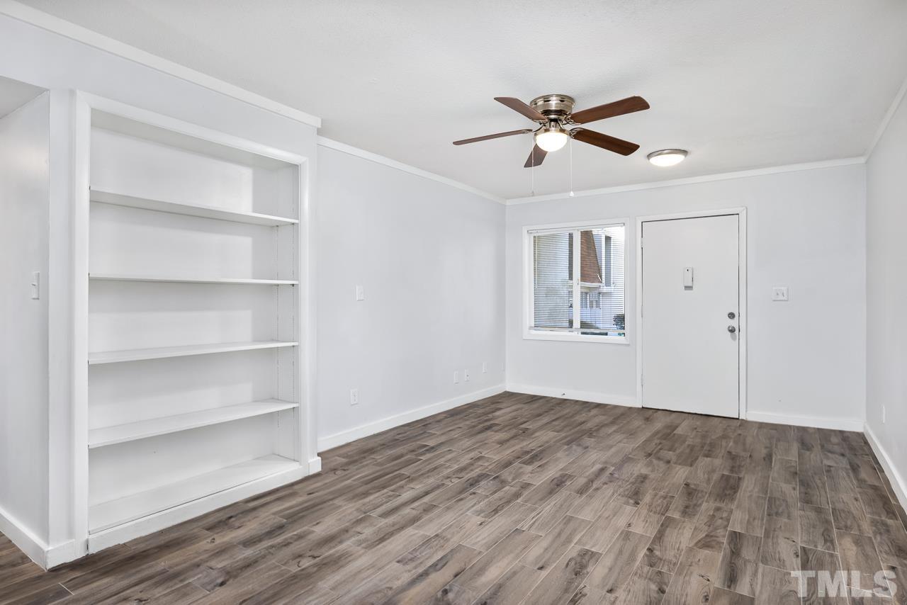 7002 Longstreet Drive, Unit C Raleigh, NC 27615 - Photo 2 of 18 a view of empty room with wooden floor and fan