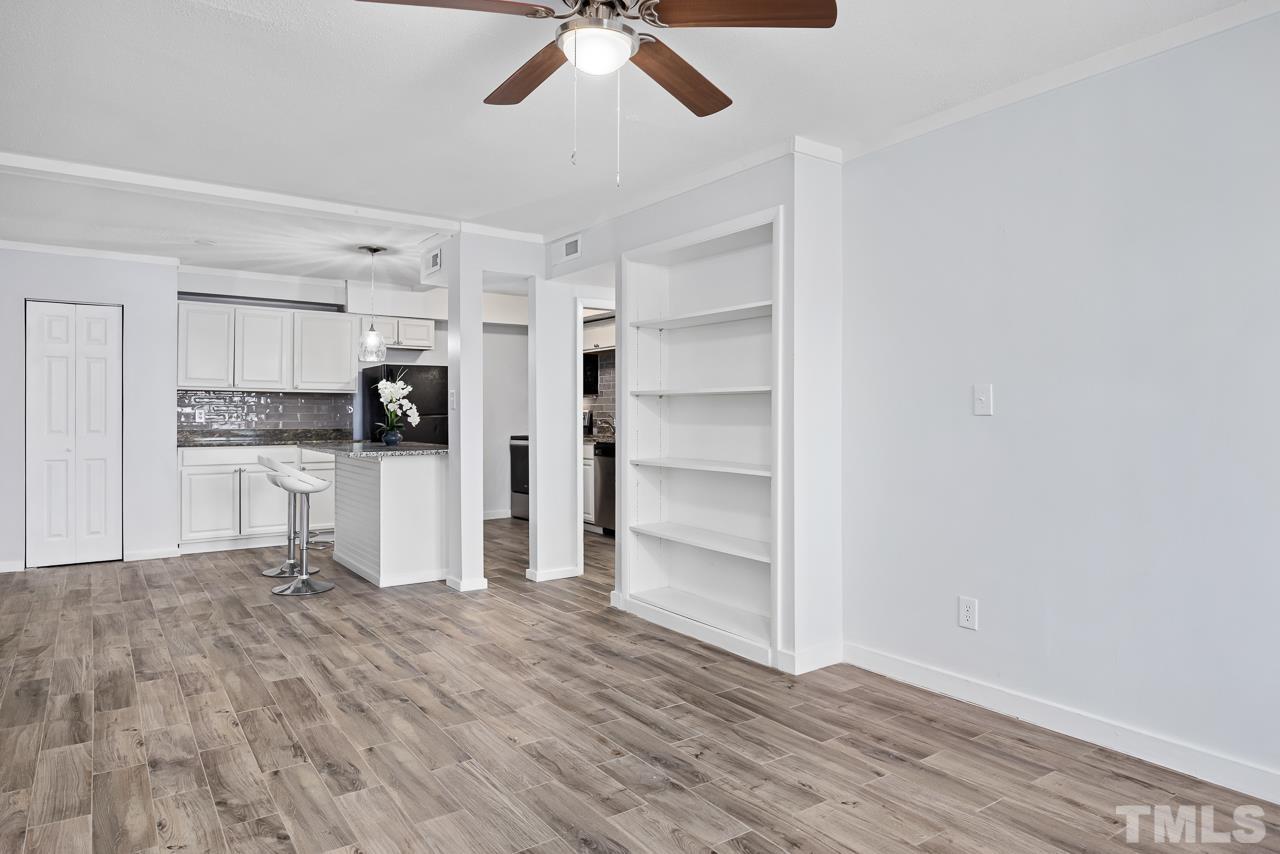 7002 Longstreet Drive, Unit C Raleigh, NC 27615 - Photo 3 of 18 a view of a kitchen with wooden floor and a ceiling fan