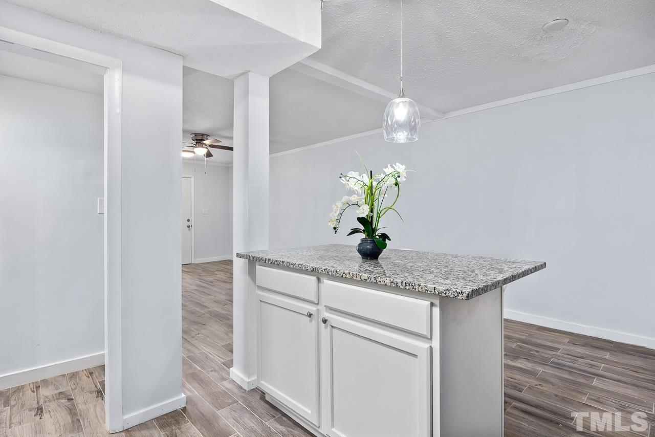 7002 Longstreet Drive, Unit C Raleigh, NC 27615 - Photo 5 of 18 a bathroom with a granite countertop sink a potted plant and a mirror