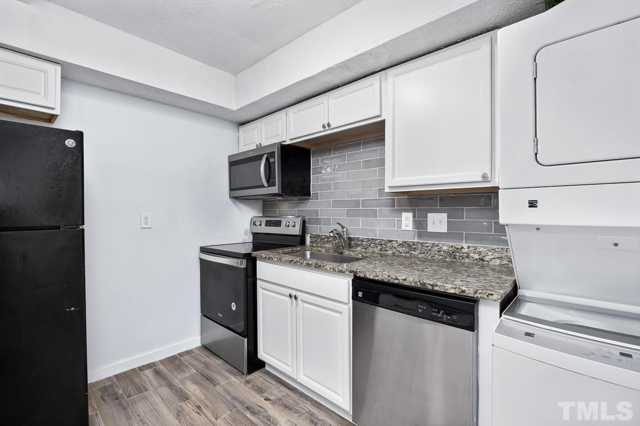 7002 Longstreet Drive, Unit C Raleigh, NC 27615 - Photo 9 of 18 a kitchen with stainless steel appliances granite countertop a sink stove and refrigerator