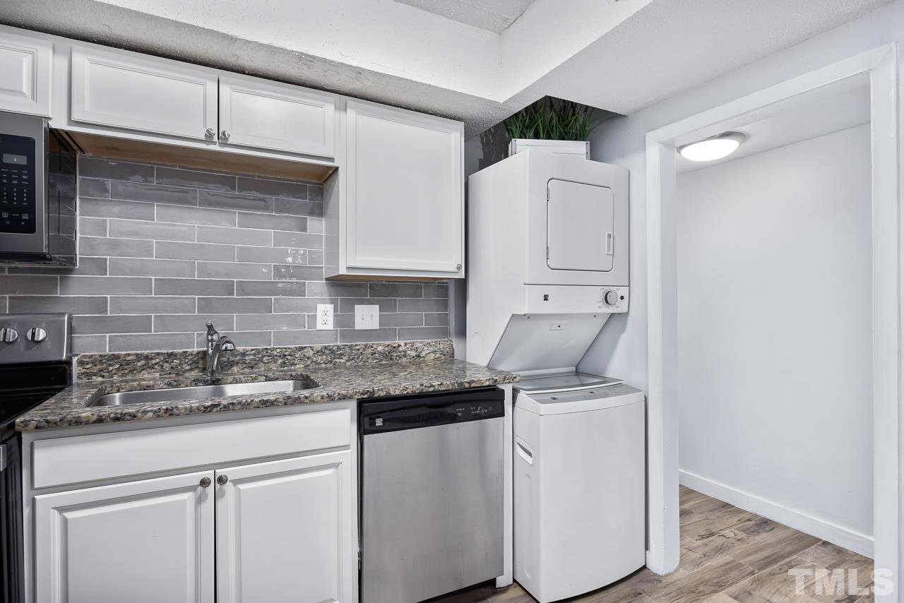 7002 Longstreet Drive, Unit C Raleigh, NC 27615 - Photo 10 of 18 a kitchen with stainless steel appliances granite countertop a sink and cabinets