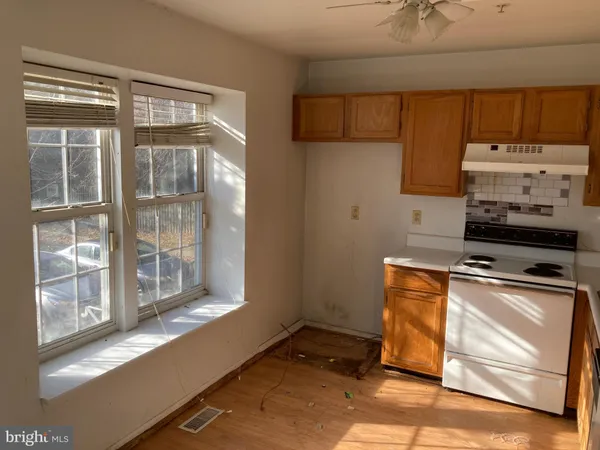 a kitchen with sink a stove and cabinets
