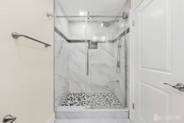 a bathroom with a granite countertop toilet a sink and a mirror