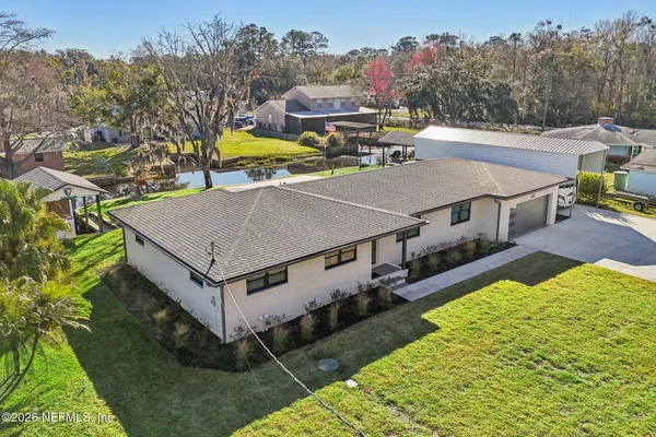 a aerial view of a house with swimming pool and big yard