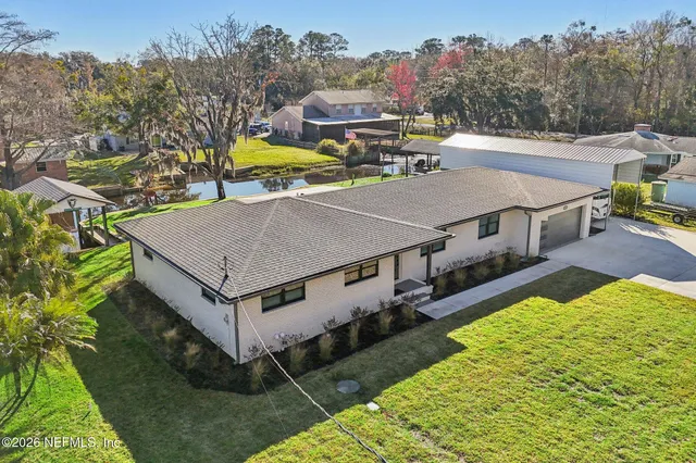 a aerial view of a house with swimming pool and big yard