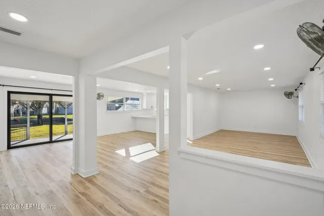 a dining room with furniture and a wooden floor
