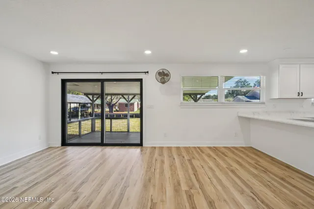 a dining room with furniture and a wooden floor