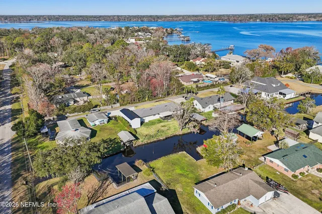 a view of wooden floor in an empty room with a window