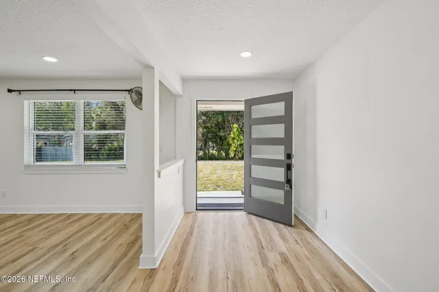 wooden floor in an empty room with a window