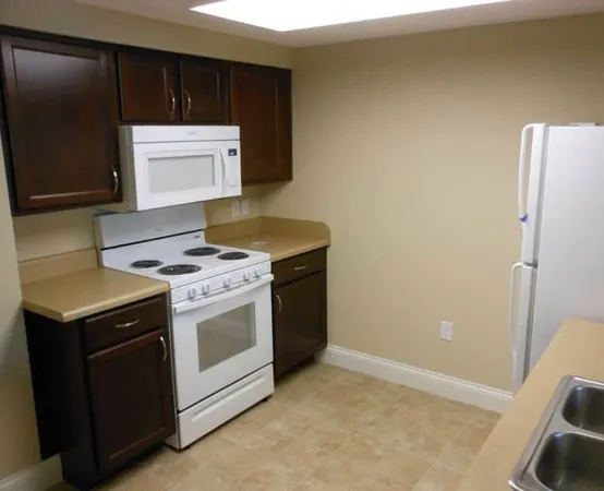 a kitchen with a stove and a refrigerator