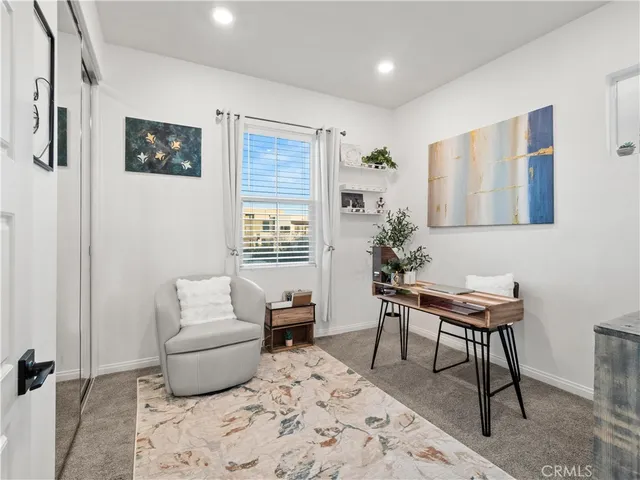 a living room with furniture a rug and a window