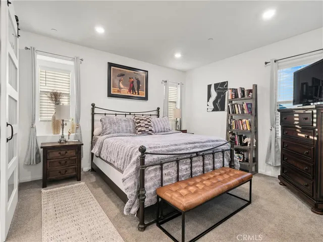 a bedroom with a bed and a tv