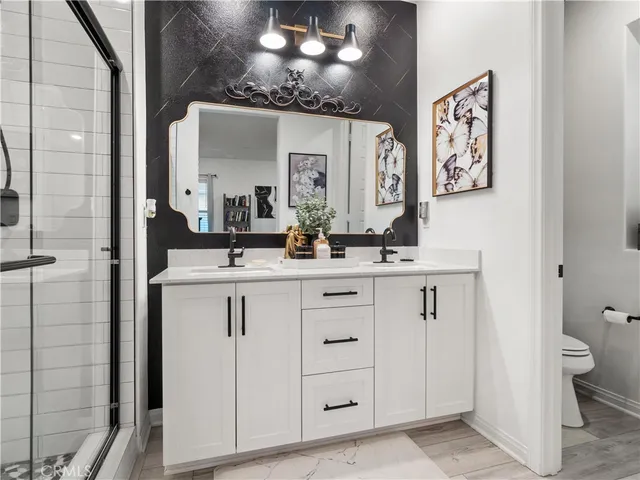 a bathroom with a double vanity sink and a mirror